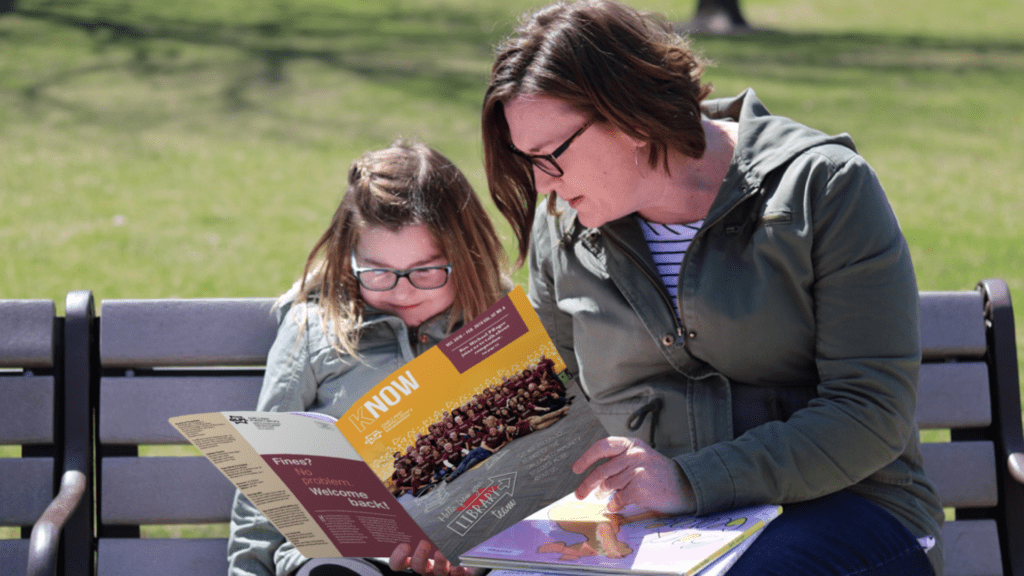 Mom and Daughter reading OLPL Newsletter